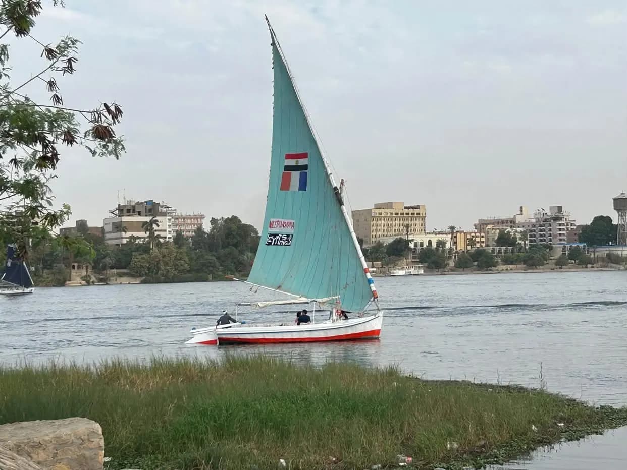 A felucca with a turquoise sail on the Nile
