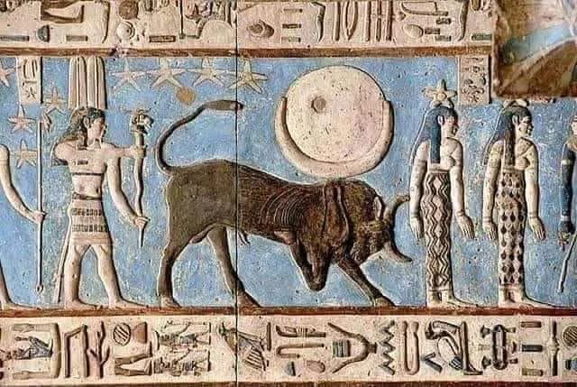 A painted ancient Egyptian ceiling relief with a bull and star symbols