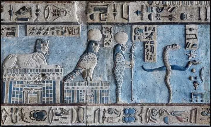 A painted blue relief with a sphinx, falcon and serpent in an ancient temple