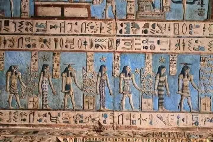 Rows of painted figures and hieroglyphs on a blue temple ceiling, Dendera