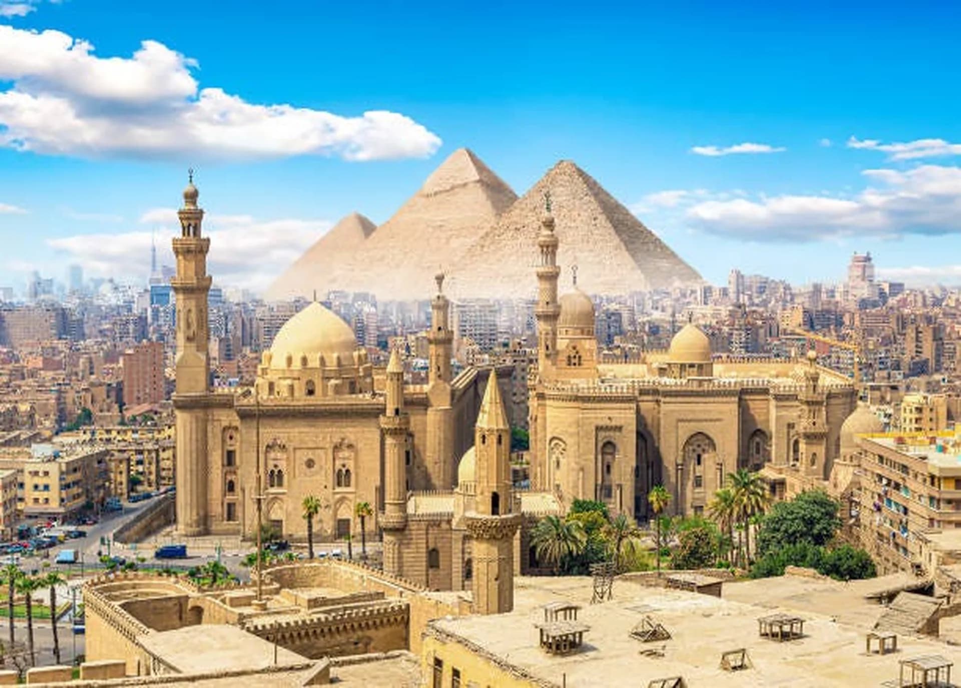 Nile-side Cairo at dusk, minarets and bridges layered into a violet sky.